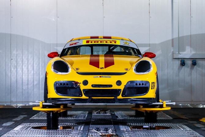 Yellow sports car perched on a platform