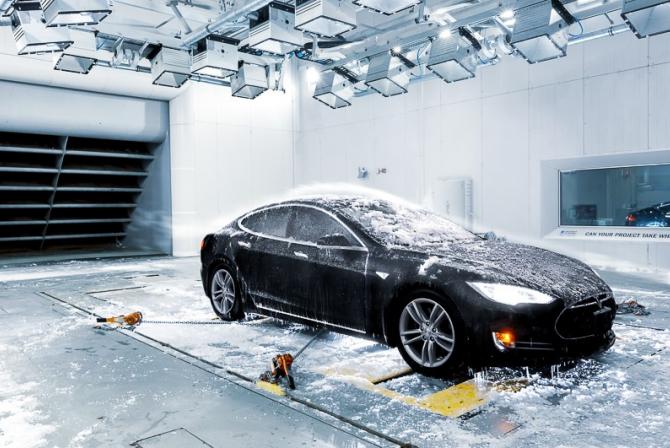 Winds and ice blown on black sports car in a test chamber 