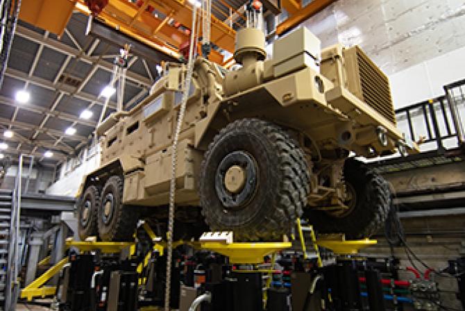 A military vehicle positioned atop test equipment