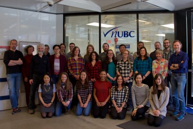 Group photo in front of the nUBC facility logo