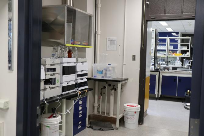 Research equipment in a room, with an open door leading to a lab