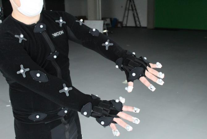 Person's torso, arms and fingers covered with small white balls.