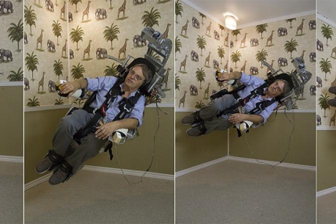 Series of 4 images showing a person buckled in a chair being spun clockwise.