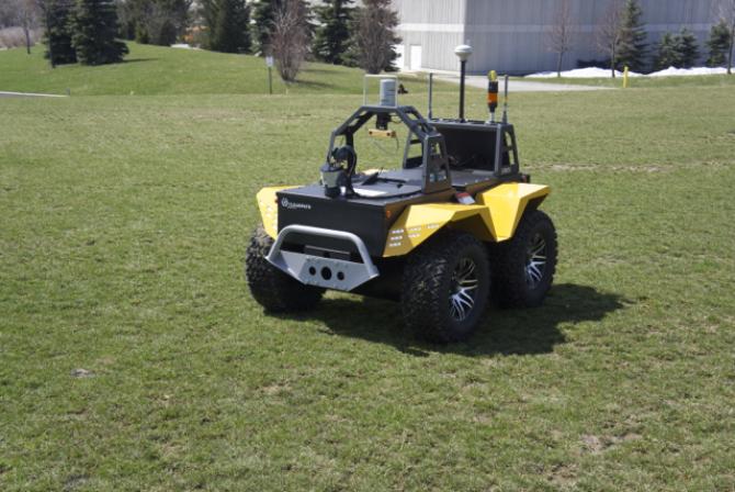 Robotic utility vehicle outdoors on grass
