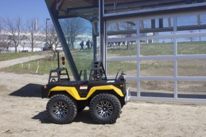 Robotic utility vehicle next to a shelter