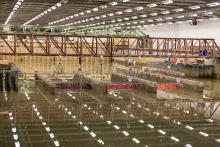 Research infrastructure and fixed structures set up within a large rectangular indoor water basin